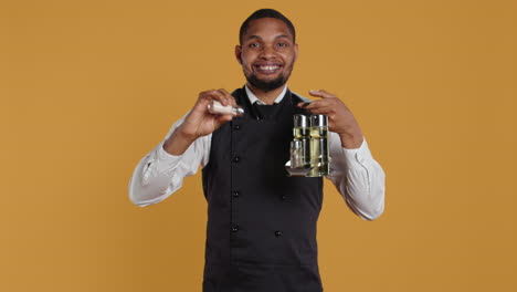 Smiling-friendly-waiter-pouring-down-salt-from-the-salt-shaker-on-the-cruet-set