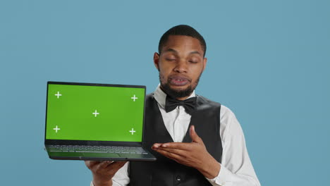 Doorkeeper-bellboy-holding-a-laptop-with-green-screen-in-studio