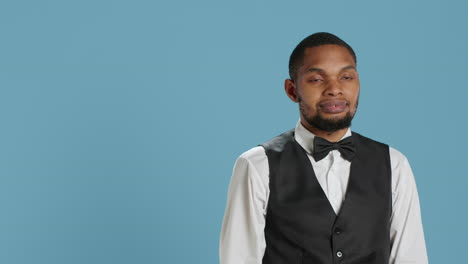 Classy-hotel-bellboy-in-tuxedo-giving-the-room-access-key-card-to-guest