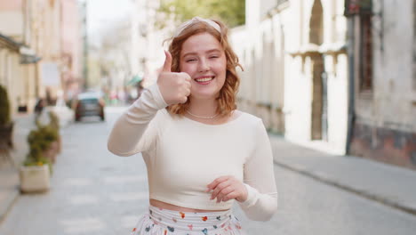 Happy-woman-showing-thumbs-up-like-sign-positive-something-good-positive-feedback-in-city-street