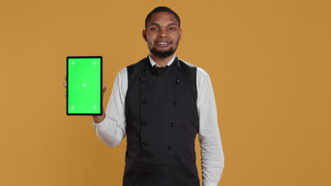 Professional-waiter-with-apron-presenting-tablet-with-isolated-mockup