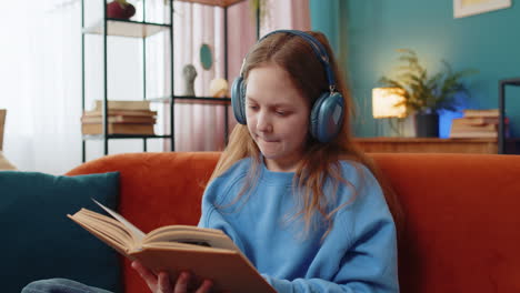 Happy-preteen-girl-in-headphones-reading-book-turning-pages-smiling-enjoying-literature-education