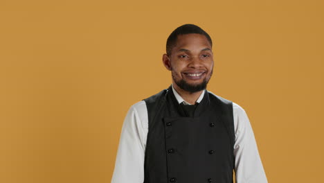 Portrait-of-restaurant-waiter-wearing-professional-uniform-and-apron