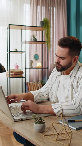 Freelancer-man-prepares-startup-project-for-presentation-finds-idea-using-laptop-at-home-office