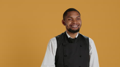 Skilled-waiter-waving-and-greeting-clients-at-five-star-restaurant