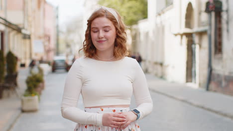 Redhead-woman-worrying-to-be-punctual-with-anxiety-checking-time-on-watch-running-late-to-work