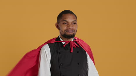 Waiter-with-a-superhero-cape-acting-as-a-savior-against-yellow-background