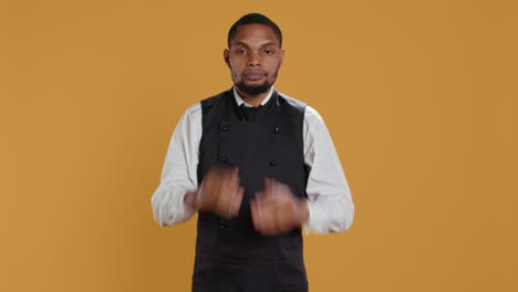 Restaurant-staff-covering-his-eyes,-mouth-and-ears-against-evil-in-studio