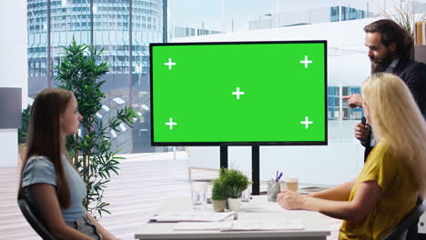 Broker-showing-stock-exchange-charts-on-green-screen-to-parent-and-girl