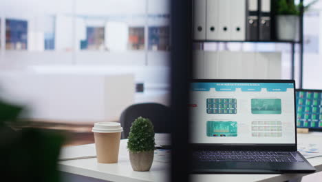 Laptop-device-on-office-desk-in-empty-workspace-showing-volatile-stock-exchange