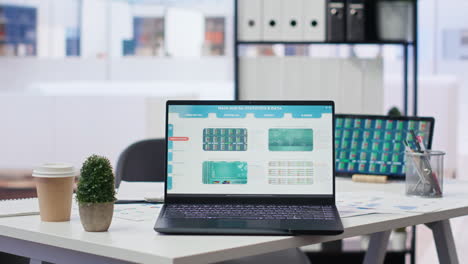 Close-up-of-devices-on-desk-next-to-paperwork-with-forex-trading-analytics