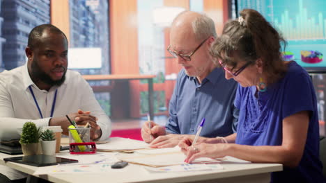 Elderly-woman-shaking-hands-with-financial-broker-in-modern-office