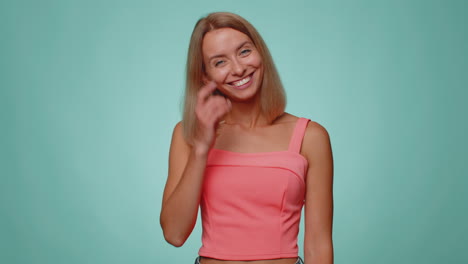 Cheerful-lovely-blonde-young-woman-fashion-model-in-crop-top-smiling-and-looking-at-camera-alone