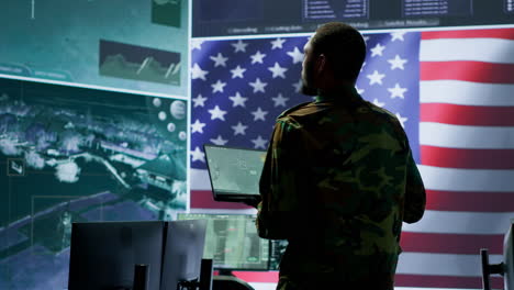 Professionals-in-US-military-uniforms-operate-computers-and-big-screen