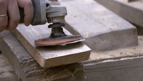 Carpenter-polishes-edge-of-new-wooden-surface-with-grinding-machine.-Shot-on-super-slow-motion-camera-1000-fps.