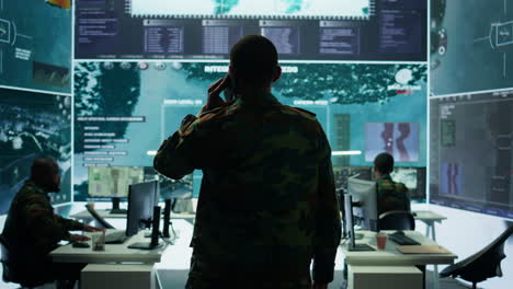 Military-man-answers-phone-call-in-a-mission-control-center