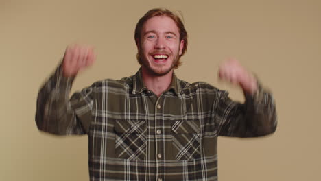 Stylish-man-in-shirt-shouting,-raising-fists-in-gesture-I-did-it,-celebrating-success,-winning