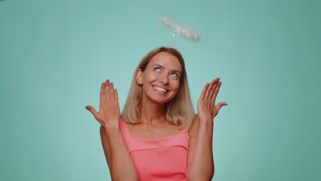 Smiling-positive-shy-angelic-woman-with-angel-halo-nimb-over-head-flirting,-looking-at-camera