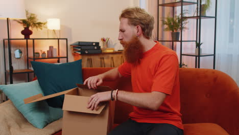 Angry-dissatisfied-shopper-man-unpacking-parcel-with-dumbbells-feeling-upset-confused-wrong-delivery