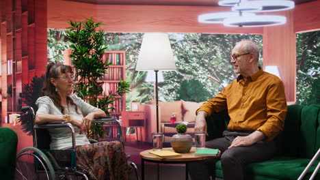 Senior-woman-in-wheelchair-smiling-and-chatting-in-a-home-care-environment