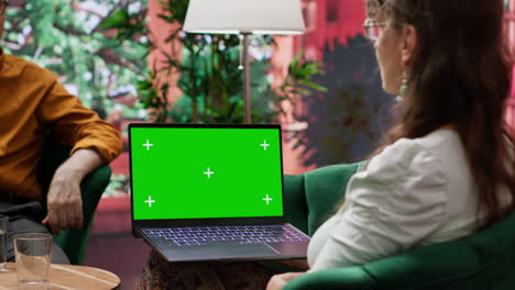 Mature-people-enjoying-leisure-time-at-home-with-green-screen-on-laptop