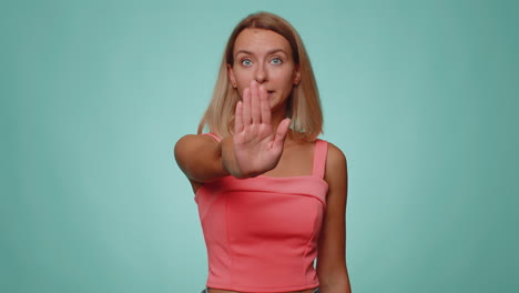 Woman-say-no-hold-palm-folded-crossed-hands-in-stop-gesture,-warning-of-finish,-prohibited-access