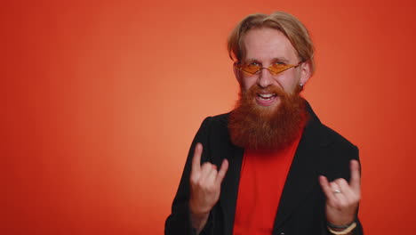 Overjoyed-happy-man-showing-rock-n-roll-gesture-by-hands,-cool-sign,-shouting-yeah-with-crazy-face