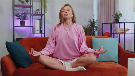 Woman-breathes-deeply-with-mudra-gesture,-eyes-closed-meditating-with-concentrated-thoughts-peaceful