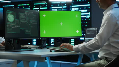 Engineer-in-server-hub-using-green-screen-PC-to-stop-hacker