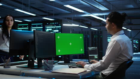 Engineer-in-data-center-monitoring-security-threats-using-mockup-computer