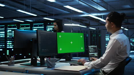 Employee-using-green-screen-devices-in-server-farm-used-for-automation