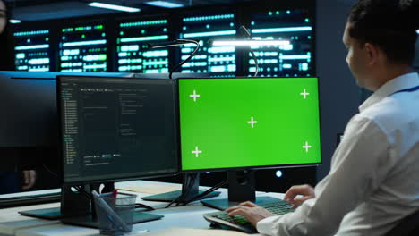 Engineer-in-data-center-monitoring-security-threats-using-mockup-computer