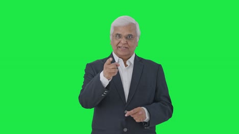 Indian-senior-journalist-reading-news-Green-screen