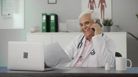 Happy-Indian-senior-doctor-explaining-reports-to-the-patient-over-call