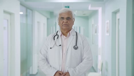 Serious-Indian-senior-doctor-looking-at-the-camera