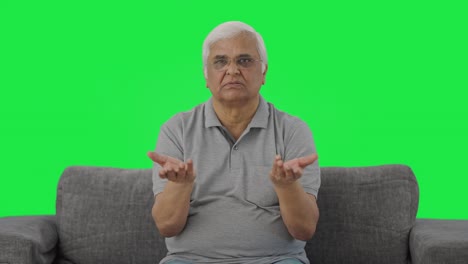 Indian-old-man-talking-to-someone-Green-screen