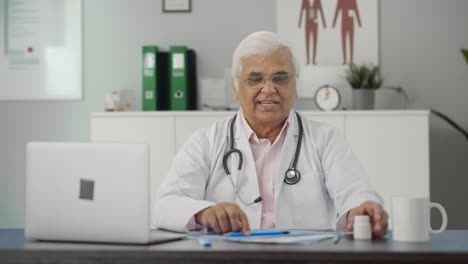 Happy-Indian-senior-doctor-explaining-reports-to-the-patient