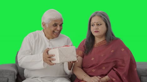 Cute-Old-Indian-husband-giving-a-gift-to-his-wife-Green-screen