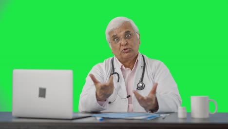 Angry-Indian-senior-doctor-shouting-on-someone-Green-screen