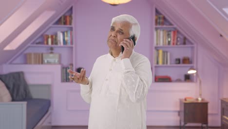 Indian-old-man-talking-on-phone