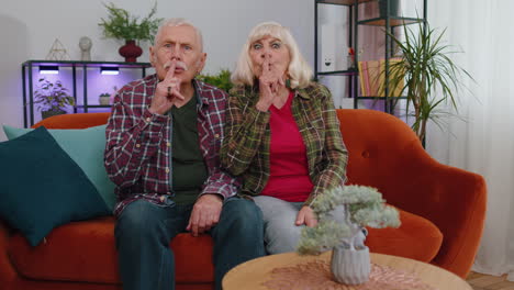 Senior-elderly-family-grandparents-man-woman-presses-index-finger-to-lips-makes-silence-gesture