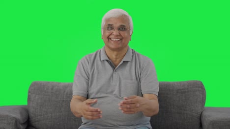 Happy-Indian-old-man-talking-Green-screen