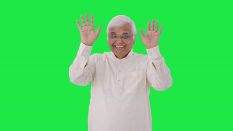 Happy-Indian-old-man-saying-hello-and-waving-hand-Green-screen