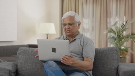 Indian-old-man-talking-on-video-call-on-laptop