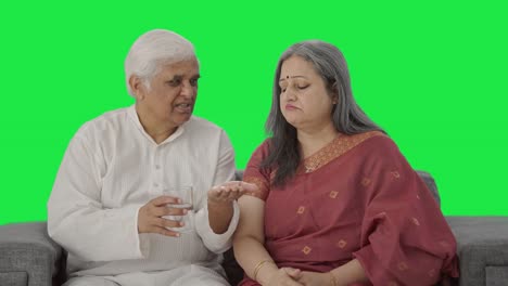 Caring-Old-Indian-man-giving-medicine-to-his-sick-wife-Green-screen