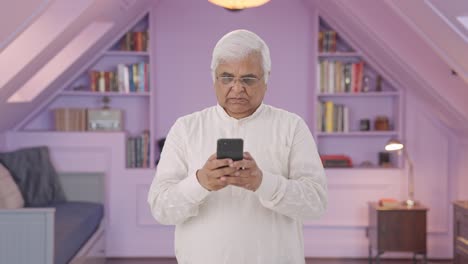 Angry-Indian-old-man-chatting-on-phone