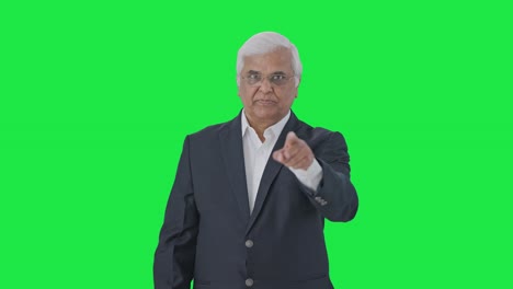 Angry-Indian-senior-journalist-reading-news-Green-screen