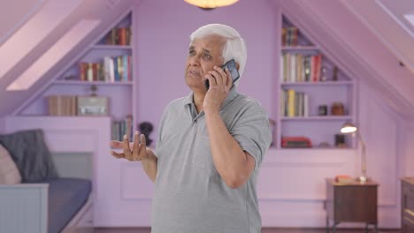 Indian-old-man-talking-on-call