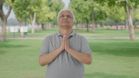 Religious-Indian-old-man-praying-to-God-in-park