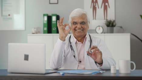 Happy-Indian-senior-doctor-showing-okay-sign